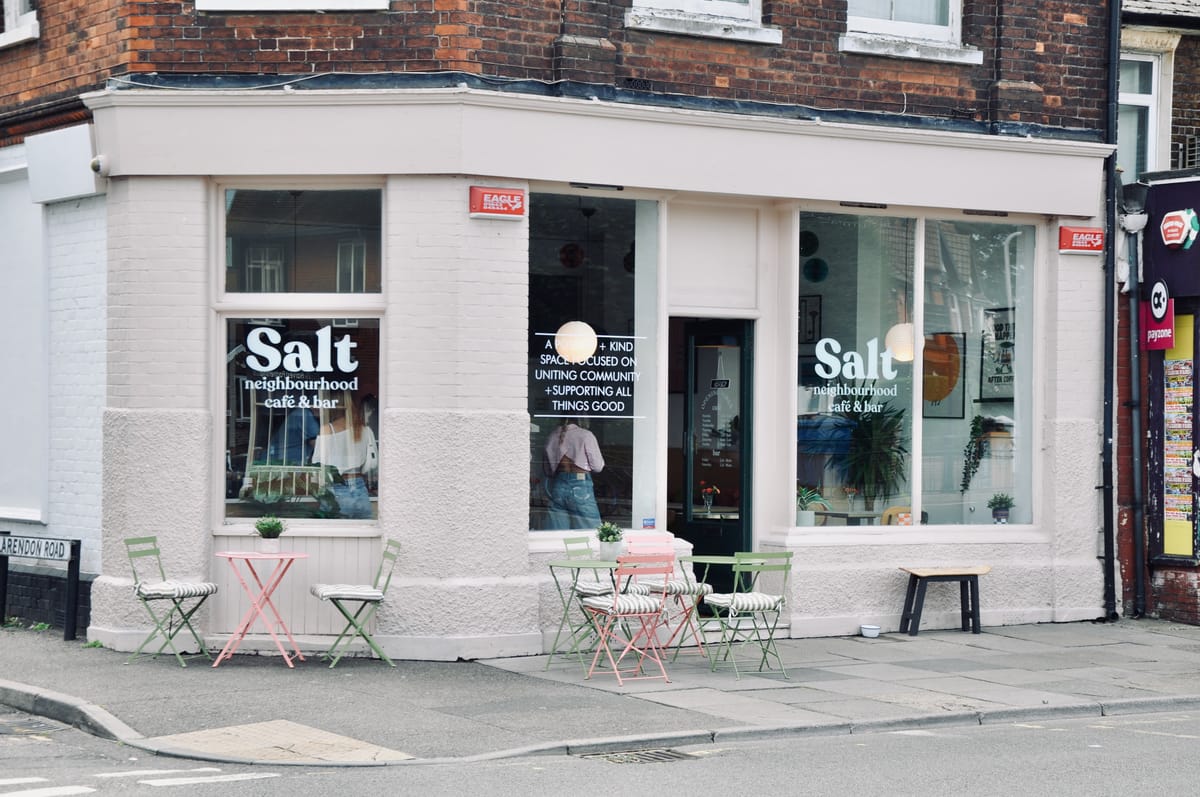 A cafe with tables and chairs outside