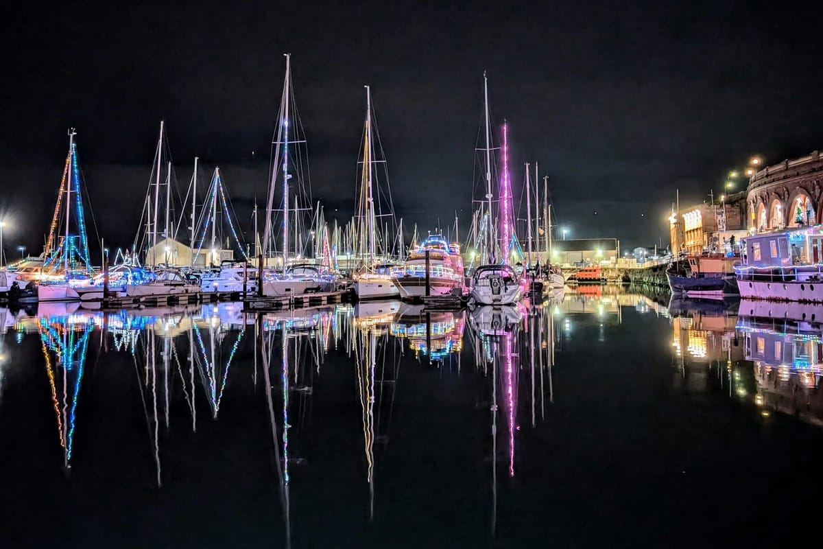 Boats in Ramsgate Harbour illuminated with Christmas lights