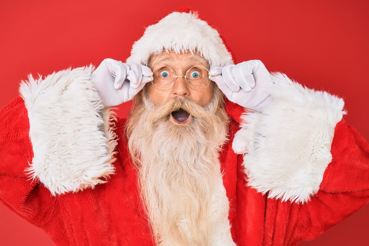 Santa adjusts his glasses in amazement 
