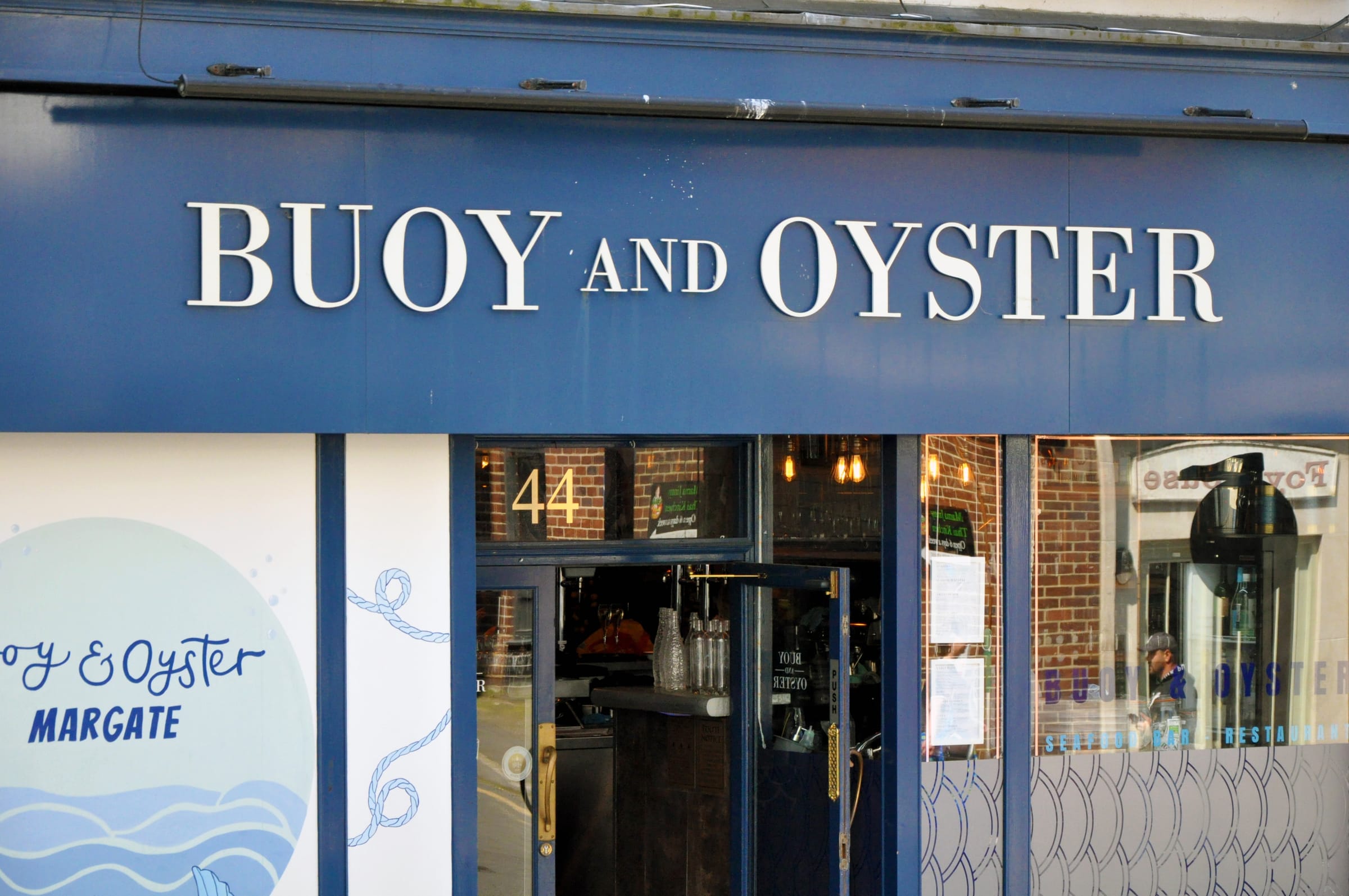 The blue frontage of a restaurant called Buoy and Oyster