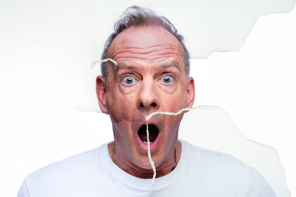 A torn up photograph of a shocked looking man